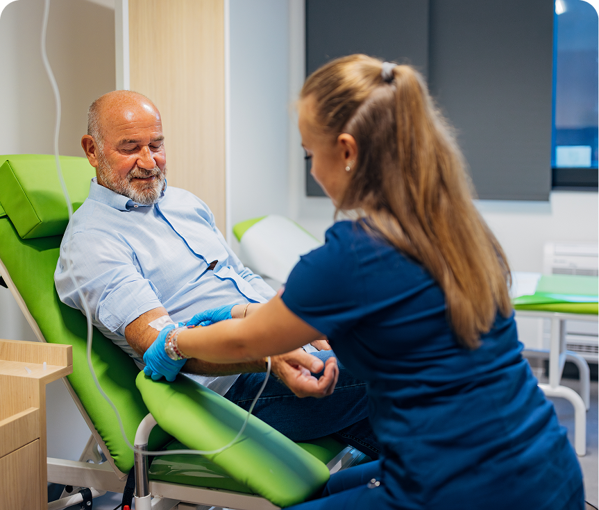 Healthcare professional assisting elderly man