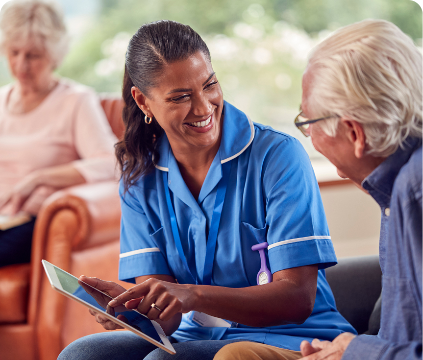 Caregiver and senior man smiling together